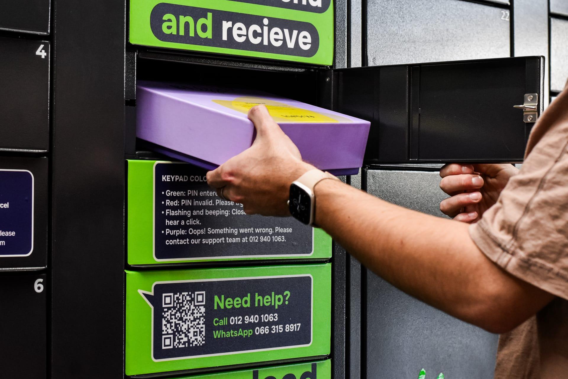 A courier scans the locker QR code and places a parcel into an open compartment.